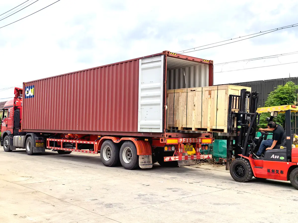 Wooden crates of OEM metal fabrication parts being loaded into a shipping container for safe export delivery.