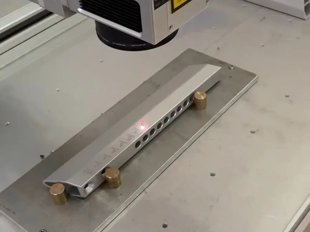 Laser marking adjustment scales on OEM spin bike components